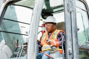 An older worker is pictured here operating a heavy piece of machinery. Learn how to help your coworkers and family members safe behind the wheel, no matter their age.