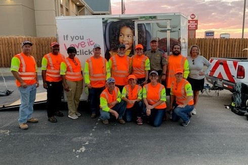 Texas Department of Transportation traffic safety specialists and coalition members work at a community seat belt safety event.