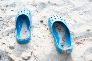 A pair of sand-filled blue flip-flops are pictured here as a way of illustration how you can leave a trail of sunshine.