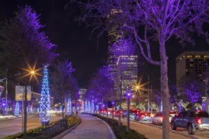 Heavy traffic lines a festive holiday street in Houston.