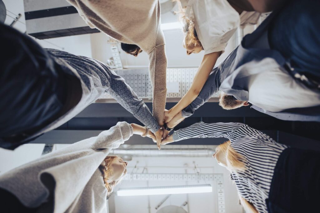 It's "hands in" for a team of workers celebrating the successful completion of a safety project.