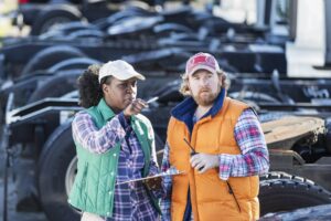 Two coworkers discuss a fleet safety report.