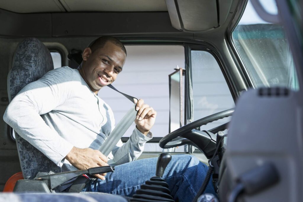 A trucker is pictured here fastening his seat belt before heading out on a journey.