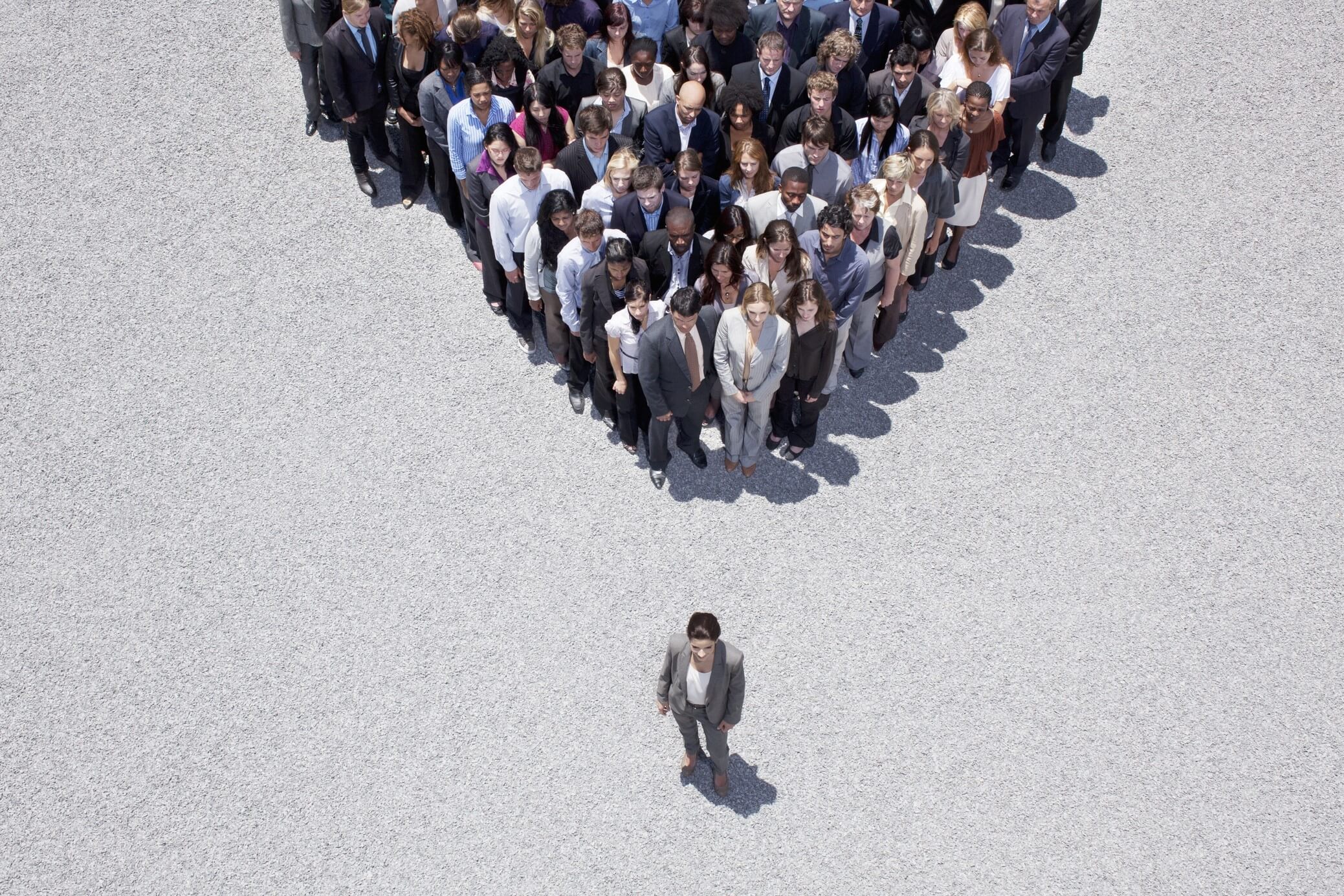 A safety leader stands in front of a crowd of employees in this illustraton. The leader's job is to foster a culture of safety.