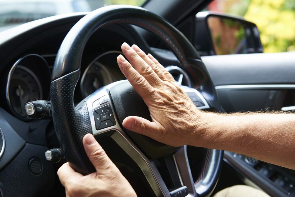 In this image, you see a driver's palm hit the horn in a moment of road rage.