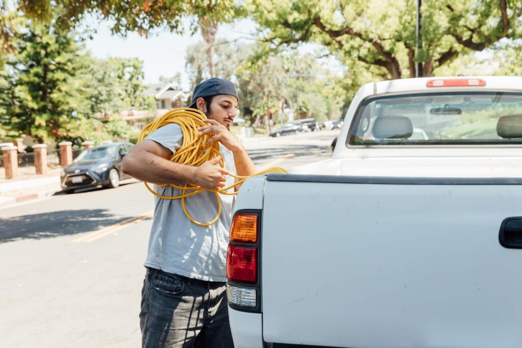 A man is pictured here removing ties as he prepares to unload his pickup truck.
