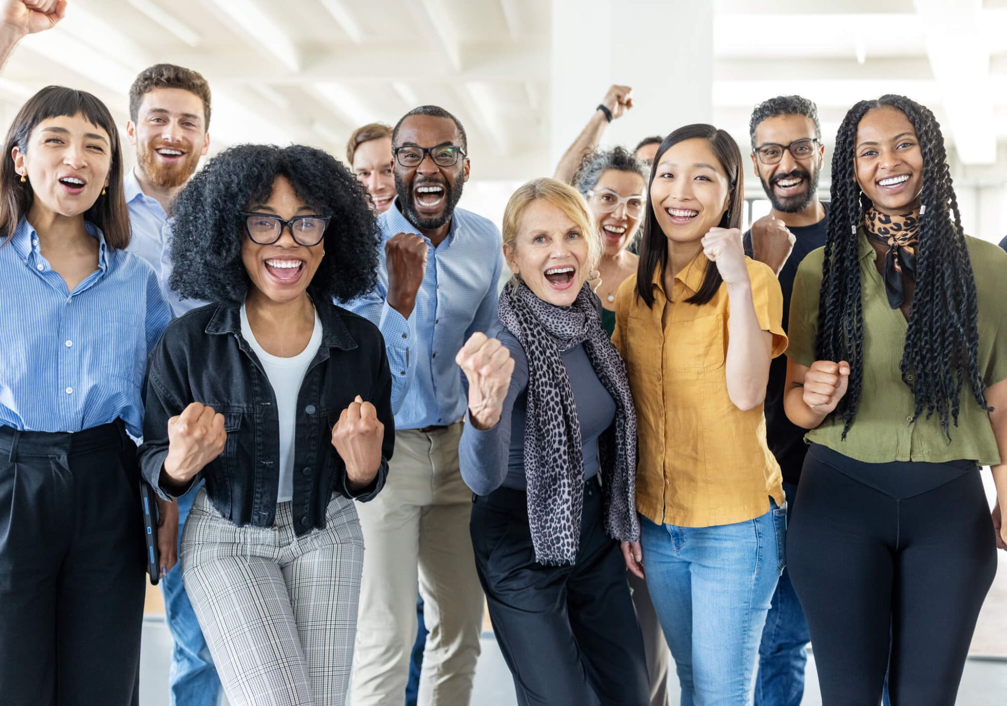 A team of coworkers celebrate after completing a project.