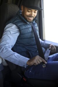 A delivery driver buckles up before heading to his next stop.